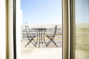 a table and chairs sitting on a balcony at Rooms Vesuvio Est in Striano