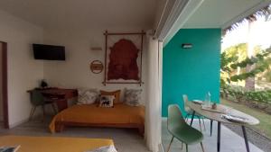 a room with a bed and a desk and a table at Studio tout confort - Hameka in Grand-Bourg