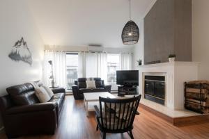 a living room with a couch and a table at Unité 26 - Ski-in Ski-out in Beaupré
