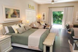 a bedroom with a large bed and a living room at Art and Accommodation Guesthouse in Cape Town +51 photos