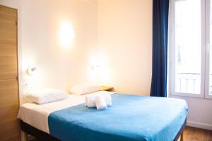 a bedroom with a bed with two towels on it at Hotel La Louisiane in Paris