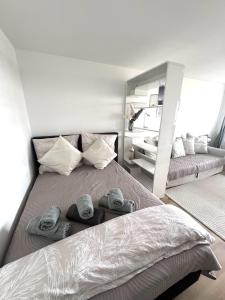 a bedroom with a large bed with towels on it at Cozy apartment with pool I U-Bahn in Munich