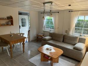 a living room with a couch and a table at Ferienhaus Fischerhaus in Zinnowitz