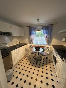 a kitchen with a table and two chairs in it at Ferienhaus Fischerhaus in Zinnowitz