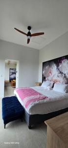 a bedroom with a large bed and a ceiling fan at Fynbos N Sea in Gansbaai