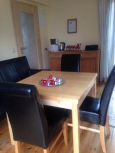 a wooden table with two black chairs and a dining room at Ferienhaus Fredy in Zinnowitz
