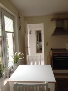a kitchen with a white table in a room at Ferienwohnung Johannes in Zinnowitz