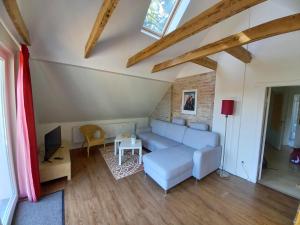 a living room with a couch and a tv at Ferienwohnung Klabautermann in Zinnowitz