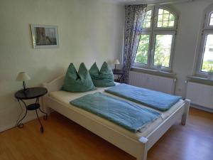 a bedroom with a bed with blue pillows on it at Ferienwohnung Klabautermann in Zinnowitz
