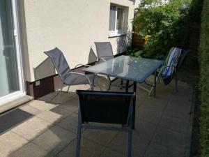 a blue table and chairs on a patio at Ferienhaus Molly in Zinnowitz +4 photos