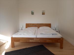 a bed in a bedroom with two lamps on the wall at Ferienhaus Lukas in Zinnowitz