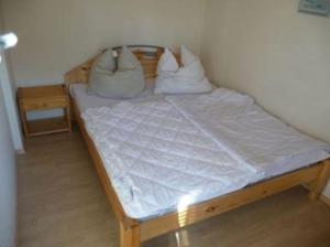 a bed in a room with two pillows on it at Bungalow Beate in Zinnowitz