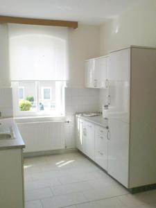 a kitchen with white appliances and a window at Ferienwohnung Michel in Ahlbeck
