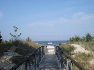 a wooden path leading to a beach with the ocean at Ferienhaus Alessandra in Zinnowitz