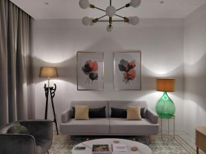 a living room with a couch and two pictures on the wall at Casa Maria in Żabbar +7 photos