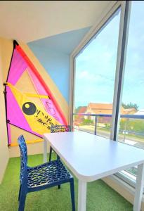 a white table and a chair in a room with a window at Appart Bréti Plage 3 - duplex avec parking a 50m de la plage in Bretignolles-sur-Mer +8 photos