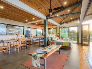 a living room and dining room with wooden ceilings at Southern Drake Lodge in Drake