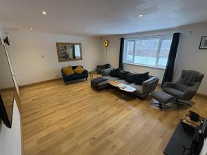 a living room with a couch and chairs and a table at Mullingar in Pitlochry