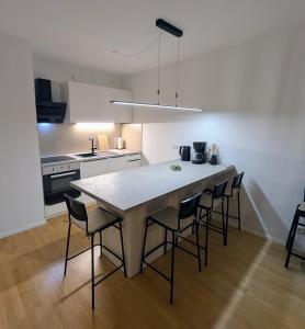 a kitchen with a large dining table and chairs at Wohnen am Wald mit Pool & Sauna in Unterkirnach