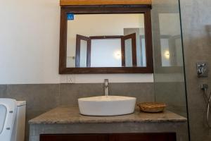 a bathroom with a sink and a mirror at Surfside Serenity - SS Beach in Ahangama +12 photos