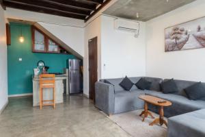 a living room with a couch and a table at Surfside Serenity - SS Beach in Ahangama
