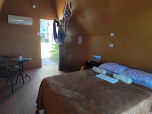 a bedroom with a large bed in a room with a table at Las Terrazas de el Alto in Chalatenango