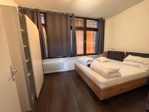 a bed in a room with a large window at Zweizimmer-Häuschen im Schwarzwald in Schopfheim