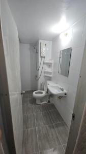 a bathroom with a toilet and a sink at Hi Impact Muangthong T9 in Nonthaburi +8 photos