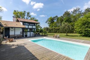 a swimming pool in front of a house at Maison humanesens in Léon