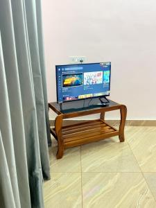 a laptop computer sitting on a table next to a curtain at Epic inn villa 3 bhk with kitchen Varkala cliff in Varkala
