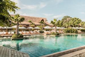 a swimming pool at a resort with chairs and umbrellas at Makani Luxury Cartagena in Tierra Bomba +62 photos