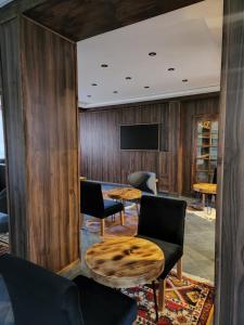 a room with a table and chairs and a tv at La Perle Ourika Valley Guest House in Ourika