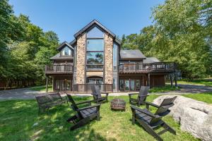 a large house with rocking chairs in the yard at Tips Up by Railey Vacations in McHenry