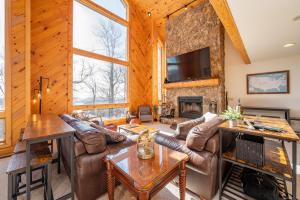 a living room with a couch and a fireplace at Tips Up by Railey Vacations in McHenry +49 photos