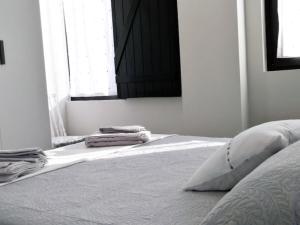 a bedroom with a bed with two pillows and a window at Apartamentos los Acantilados Nº 1 Cobreces in Cóbreces +1 photo