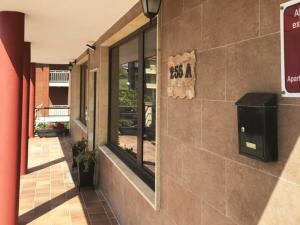 a building with a sign on the side of it at Apartamentos los Acantilados Nº 1 Cobreces in Cóbreces