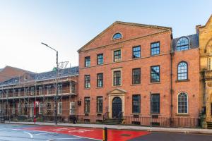 a large brick building on a city street at Leeds City Luxe Apartment with Parking, 8 mins to station! in Central Station +75 photos