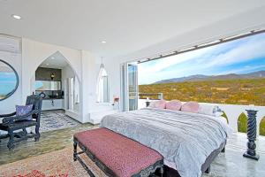 a bedroom with a bed and a large window at The Moroccan Palace Entire Villa in El Sargento