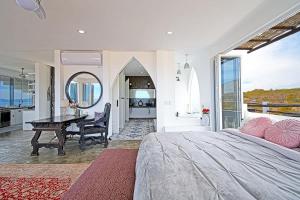a bedroom with a large bed and a table at The Moroccan Palace Entire Villa in El Sargento