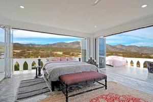 a bedroom with a bed and a large window at The Moroccan Palace Entire Villa in El Sargento