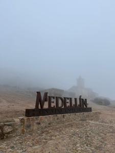 a sign in the middle of a desert with a foggy at Apartamento Casa Nela in Medellín