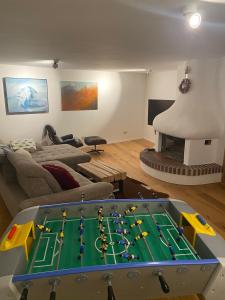 a living room with a pool table and a couch at ParkSuite Aflenz Kurort in Aflenz Kurort
