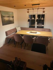 a living room with a table and a couch at ParkSuite Aflenz Kurort in Aflenz Kurort +7 photos