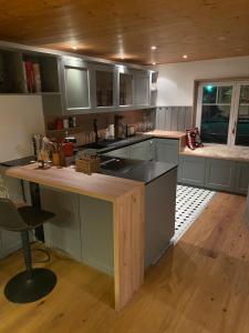 a kitchen with gray cabinets and a wooden ceiling at ParkSuite Aflenz Kurort in Aflenz Kurort