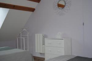 a bedroom with a bed and a mirror and a dresser at L etoile bleue in Fossé