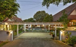 an external view of a house with a swimming pool at Whisper Oasis - Award-Winning Private Jacuzzi Pool Villa - 3BR, Daily Service in Chiang Mai