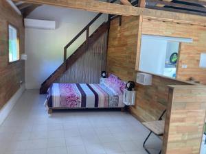 a bedroom with a bed with a wooden wall at L'Alamanda in Trois-Rivières