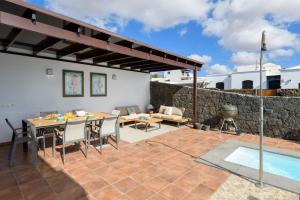 a patio with a table and chairs and a pool at Villa Europa in Nazaret