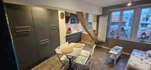 a small kitchen with a table and chairs in a room at Le petit Rouen in Rouen
