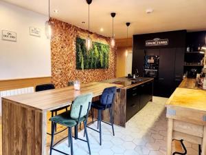 a kitchen with a large wooden table and chairs at Gîte grand confort 15 personnes - Le Domaine - Wimereux in Wimereux